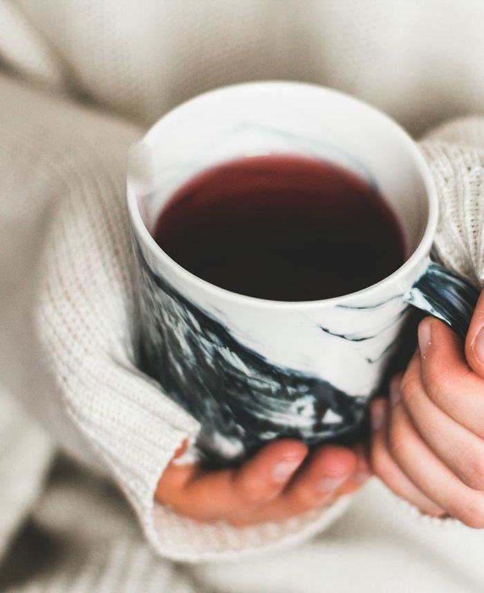 Hands holding a mug of tea
